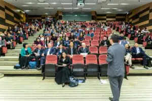 Man Standing In Front Of People